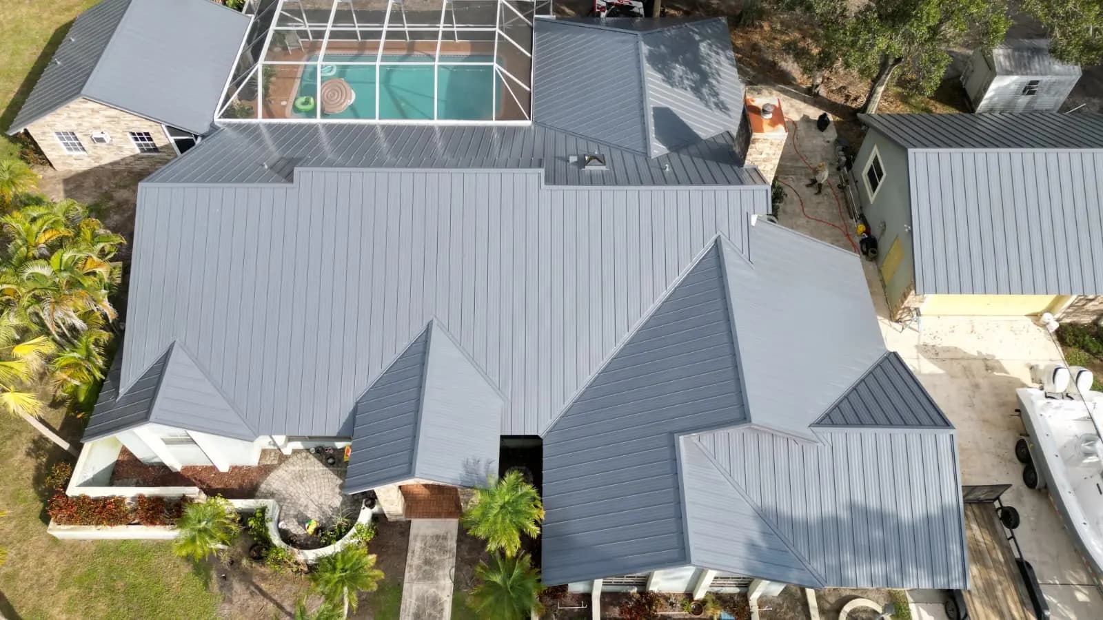 Charcoal metal roof toward a screened enclosure