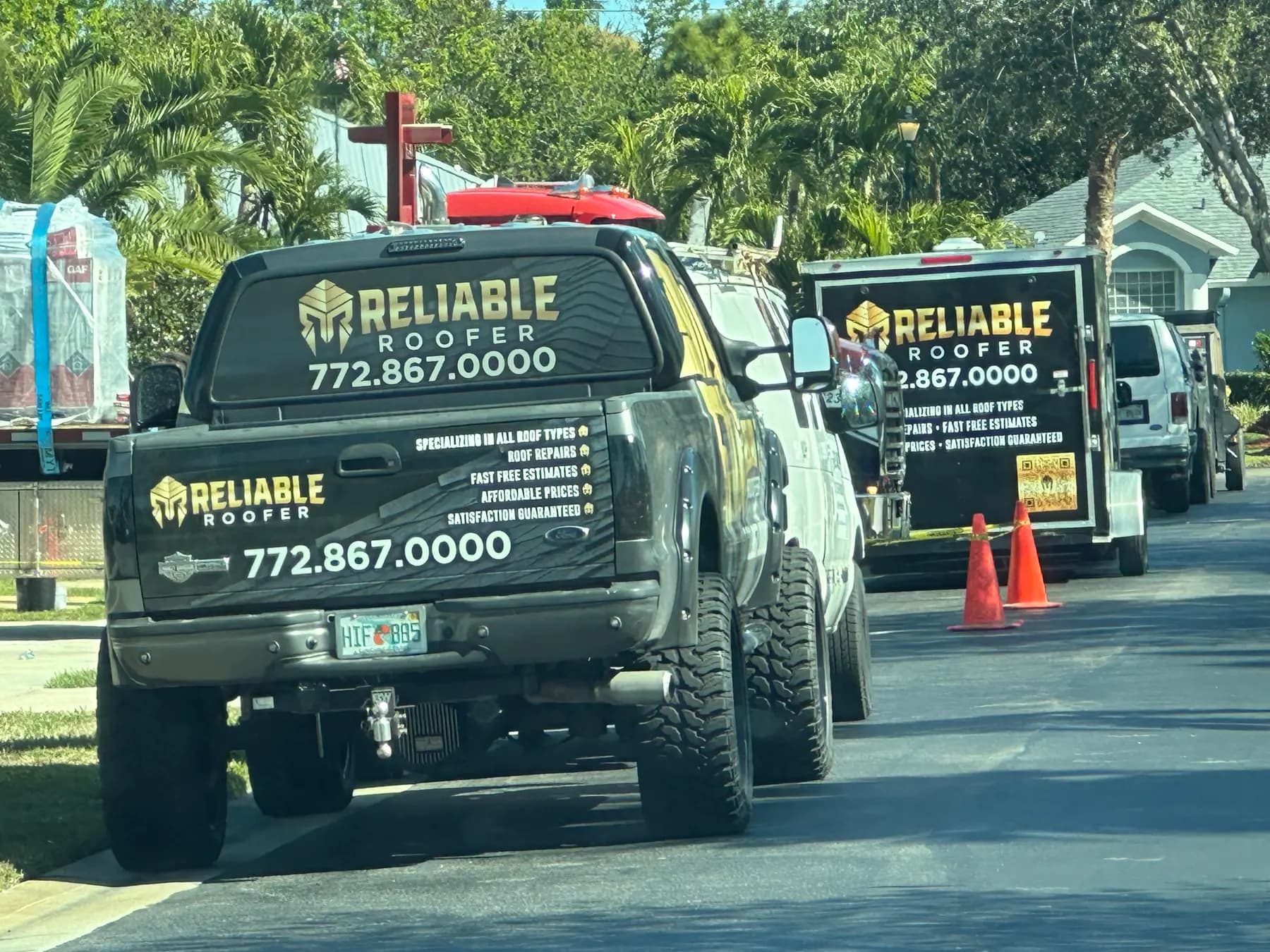 Branded truck and trailer parked curbside at a residential job