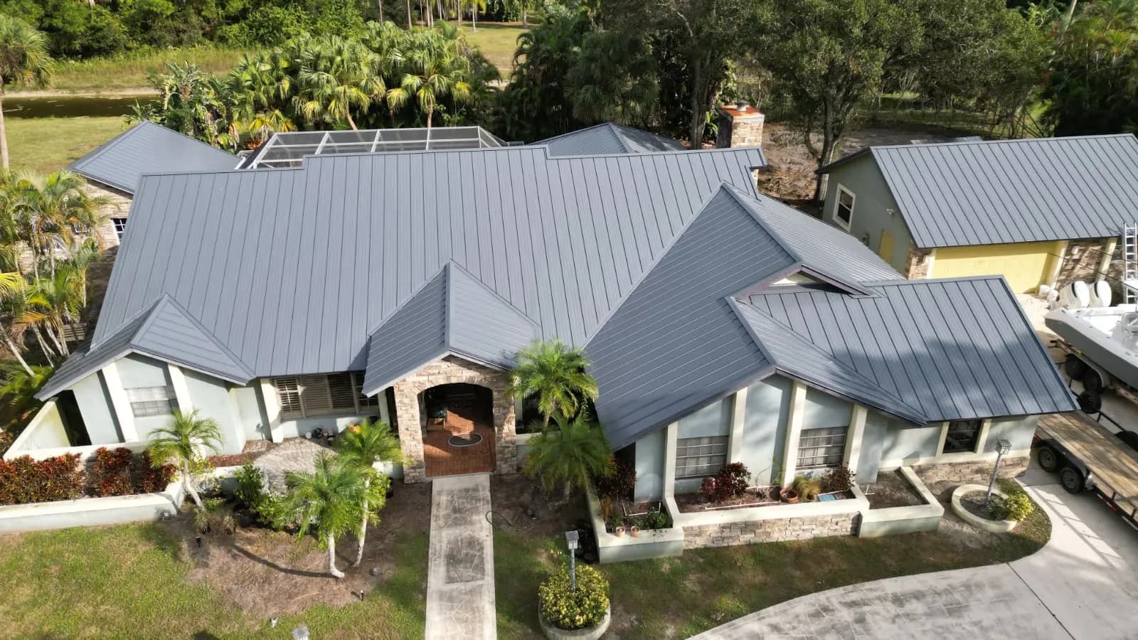 Charcoal standing-seam metal over the front elevation