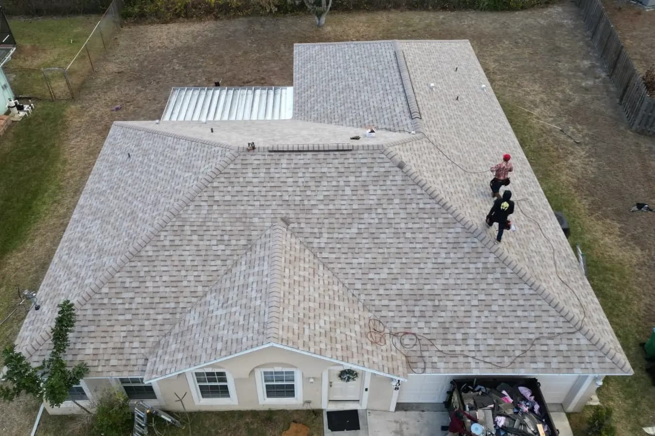 Tan architectural shingle roof after replacement