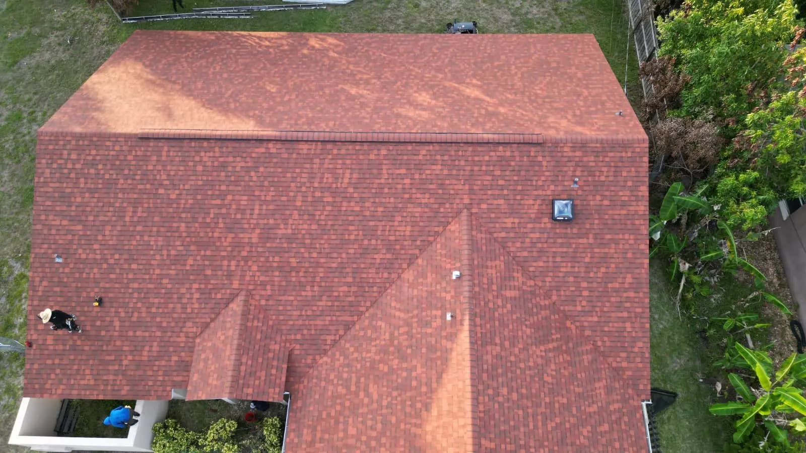 Reddish-brown architectural shingles — terracotta tone, not clay tile